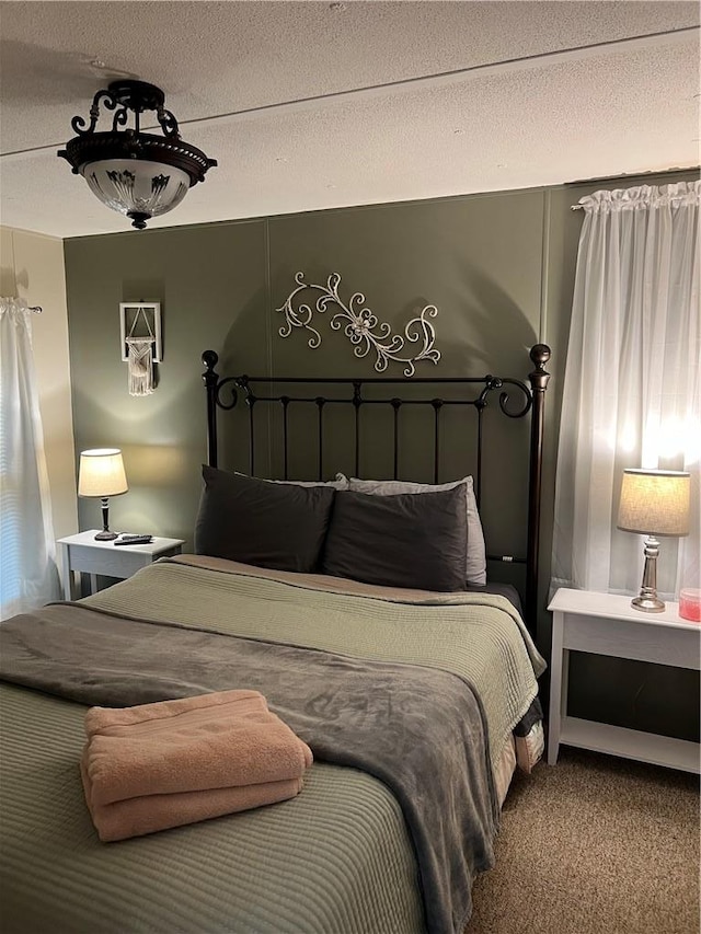 carpeted bedroom with a textured ceiling