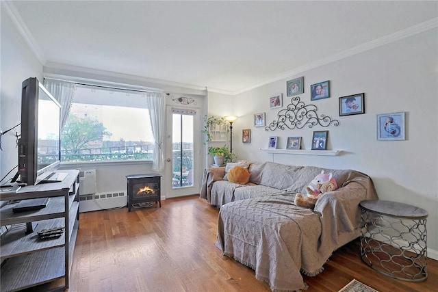 living room with wood-type flooring and ornamental molding