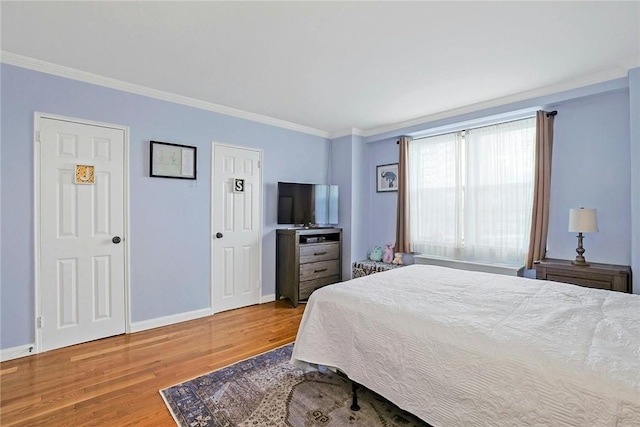 bedroom with crown molding and hardwood / wood-style flooring