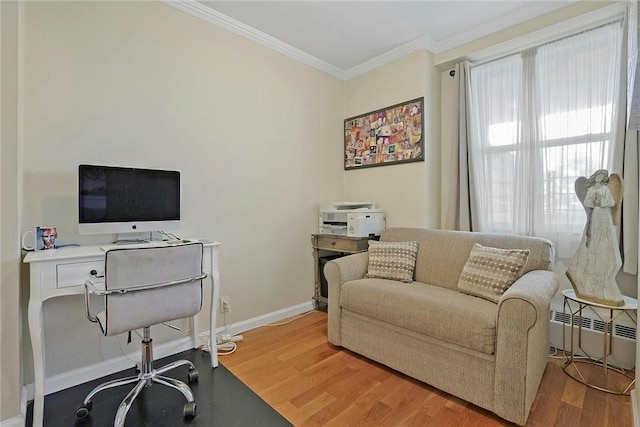 home office with radiator, crown molding, and hardwood / wood-style floors