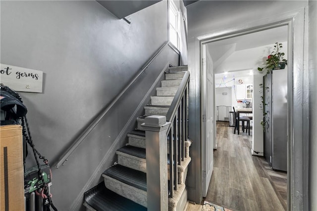 stairs with hardwood / wood-style floors