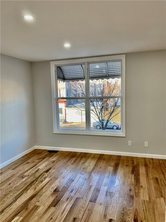 spare room with a healthy amount of sunlight and light wood-type flooring