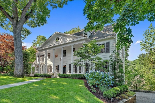 neoclassical home with a front lawn