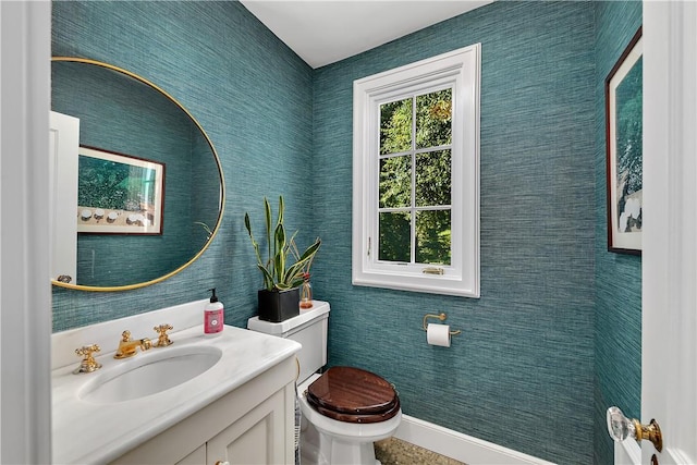 bathroom featuring vanity and toilet