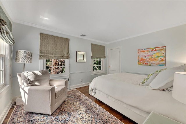 bedroom featuring dark hardwood / wood-style flooring and ornamental molding