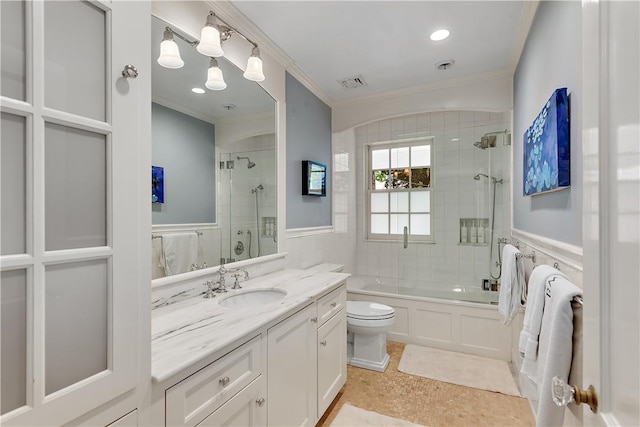 full bathroom featuring vanity, crown molding, enclosed tub / shower combo, and toilet