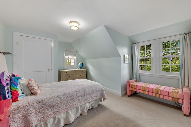 carpeted bedroom featuring lofted ceiling