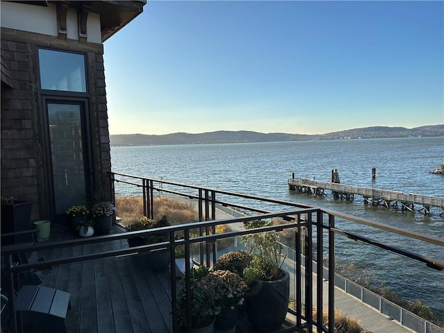 view of dock featuring a water and mountain view