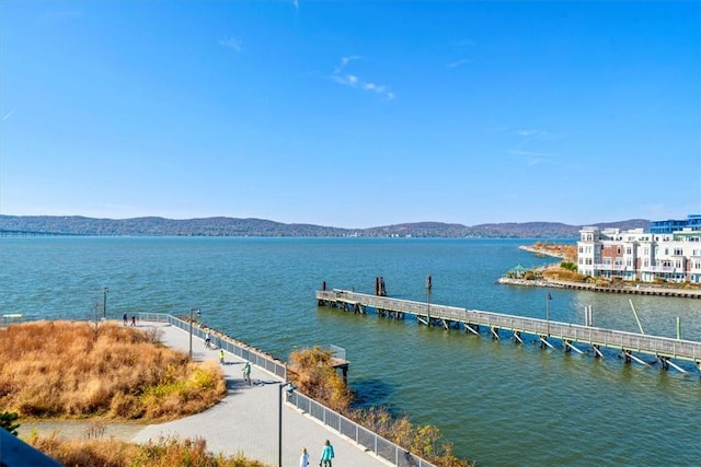 view of dock with a water and mountain view