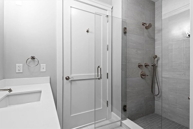 bathroom featuring tile patterned flooring, vanity, and walk in shower