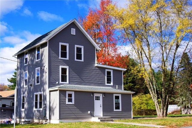 rear view of property with a yard