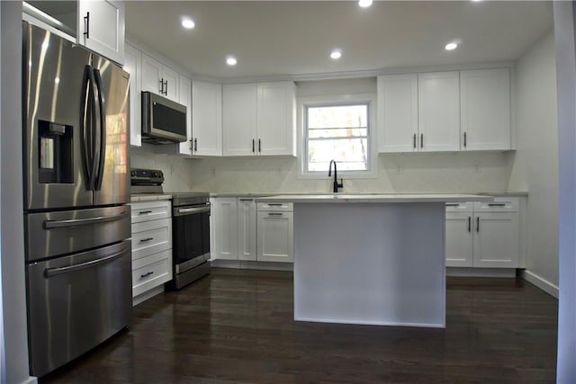 kitchen with white cabinetry, sink, dark wood-type flooring, and appliances with stainless steel finishes