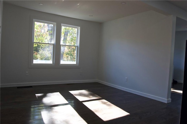 unfurnished room with dark hardwood / wood-style floors