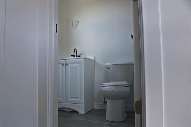 bathroom with hardwood / wood-style floors and toilet