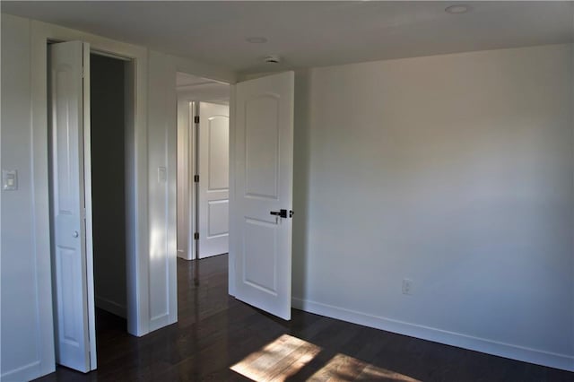 unfurnished bedroom featuring dark hardwood / wood-style floors