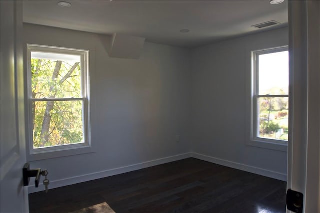 spare room with dark wood-type flooring