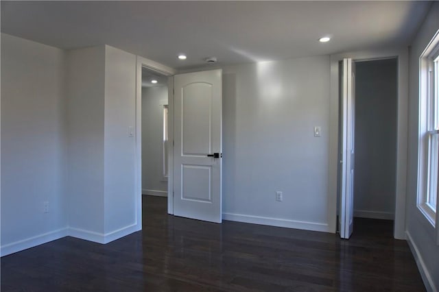 empty room with dark hardwood / wood-style flooring