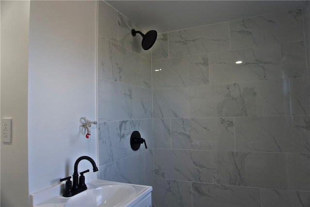 bathroom with sink and tiled shower