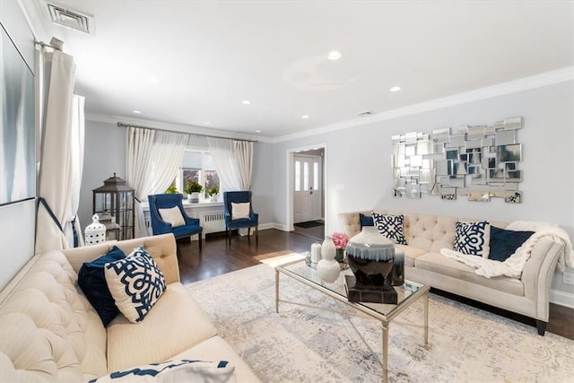 living room featuring radiator, crown molding, and wood-type flooring