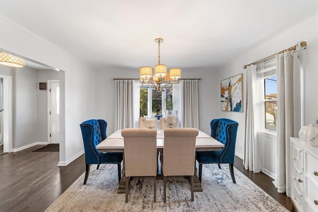 dining space featuring an inviting chandelier and dark wood-type flooring