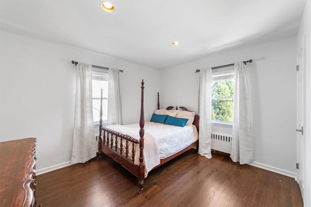 bedroom featuring radiator and dark hardwood / wood-style floors