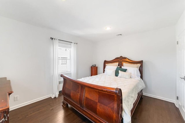 bedroom with dark hardwood / wood-style floors