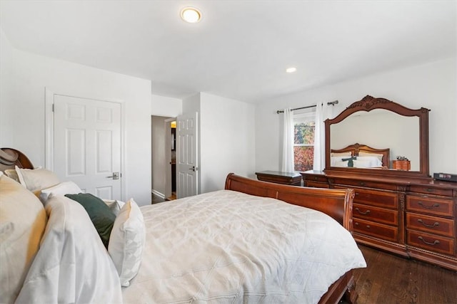 bedroom with dark wood-type flooring