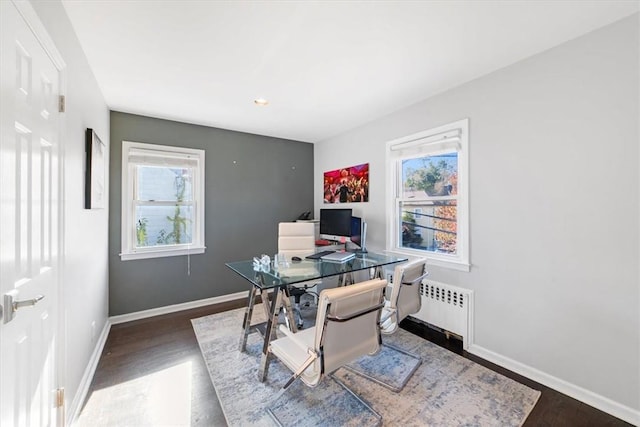 home office featuring dark hardwood / wood-style flooring and radiator