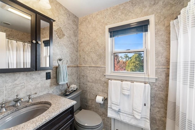 bathroom with vanity, toilet, tile walls, and backsplash