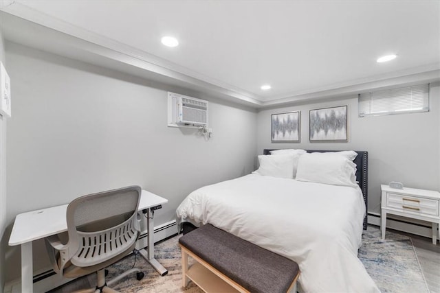 bedroom with baseboard heating and a wall unit AC