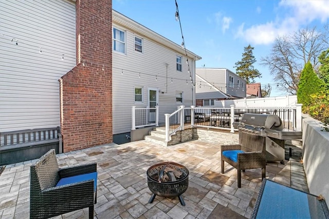 view of patio / terrace with a fire pit and area for grilling