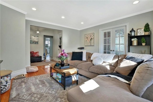 living room with wood-type flooring, french doors, and crown molding