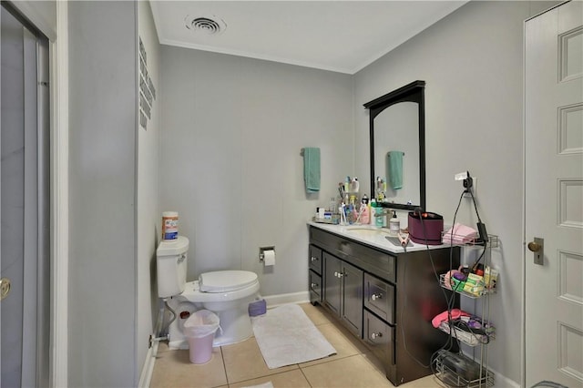 bathroom with toilet, vanity, and tile patterned floors