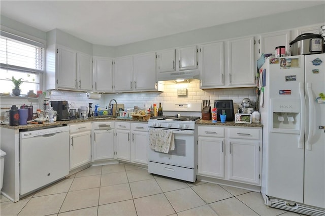 kitchen featuring light tile patterned floors, white cabinets, and white appliances