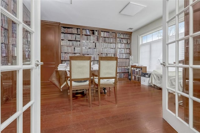 dining area with french doors and hardwood / wood-style flooring