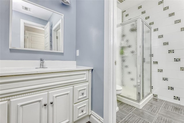 bathroom featuring vanity, toilet, and walk in shower