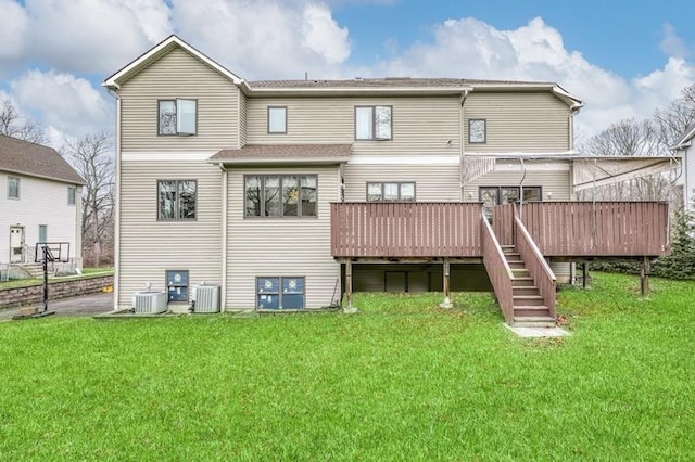 rear view of house with central AC, a lawn, and a wooden deck