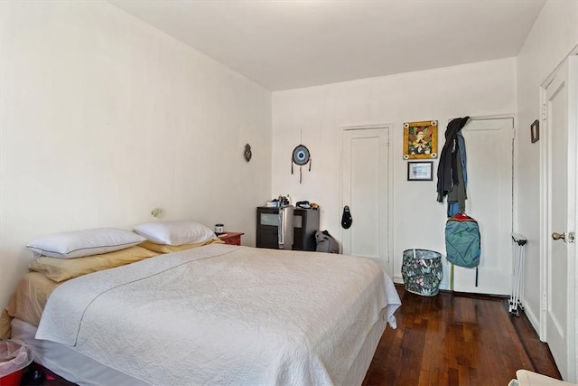 bedroom with dark hardwood / wood-style floors