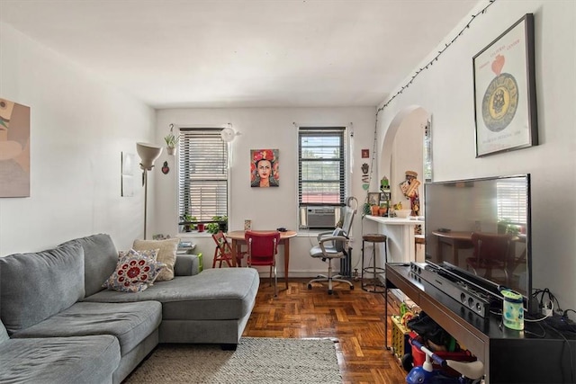 living room featuring cooling unit and dark parquet flooring