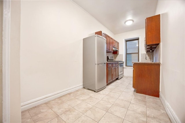 kitchen with sink, light tile patterned flooring, and stainless steel appliances