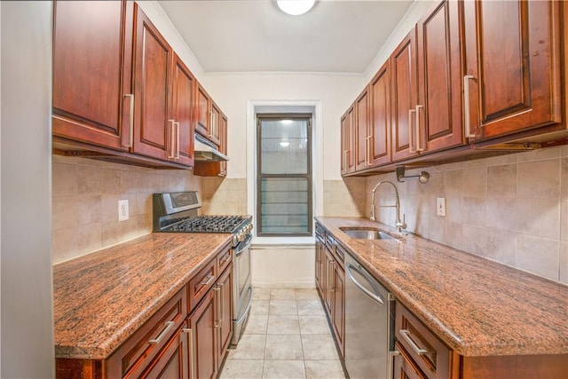 kitchen with sink, stainless steel appliances, tasteful backsplash, stone countertops, and light tile patterned floors