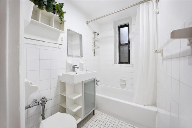 full bathroom featuring shower / tub combo with curtain, sink, tile walls, tile patterned flooring, and toilet