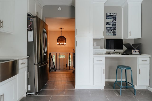 kitchen featuring white cabinetry, stainless steel fridge, pendant lighting, and dark tile patterned flooring