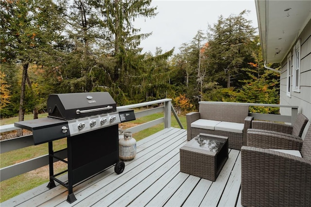 wooden deck with grilling area and an outdoor hangout area