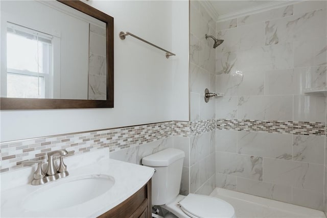 bathroom featuring a tile shower, vanity, toilet, and tile walls