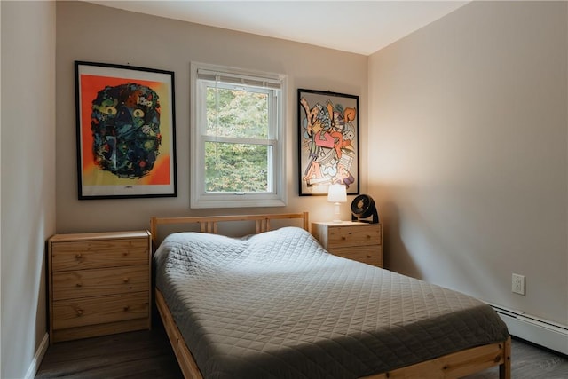 bedroom featuring dark hardwood / wood-style flooring and a baseboard heating unit