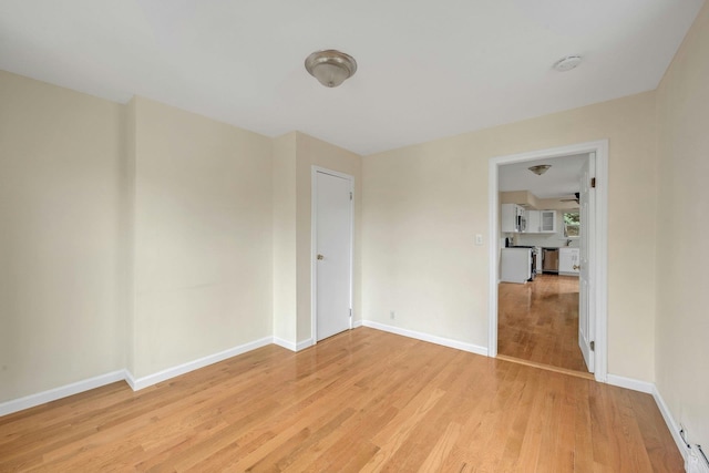 unfurnished room with light wood-type flooring