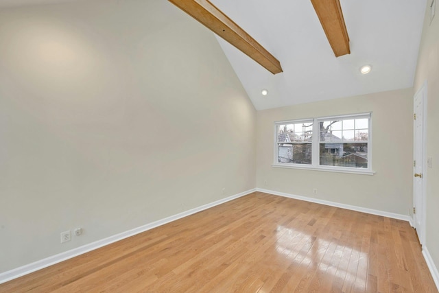 unfurnished room with beam ceiling, high vaulted ceiling, and light hardwood / wood-style flooring