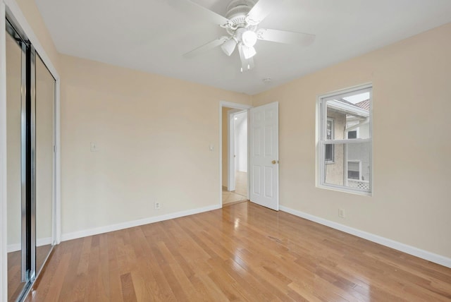 unfurnished bedroom with light wood-type flooring, a closet, and ceiling fan