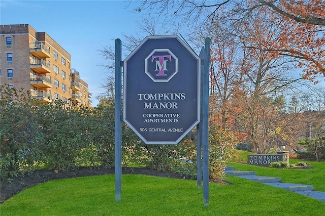 community sign featuring a lawn